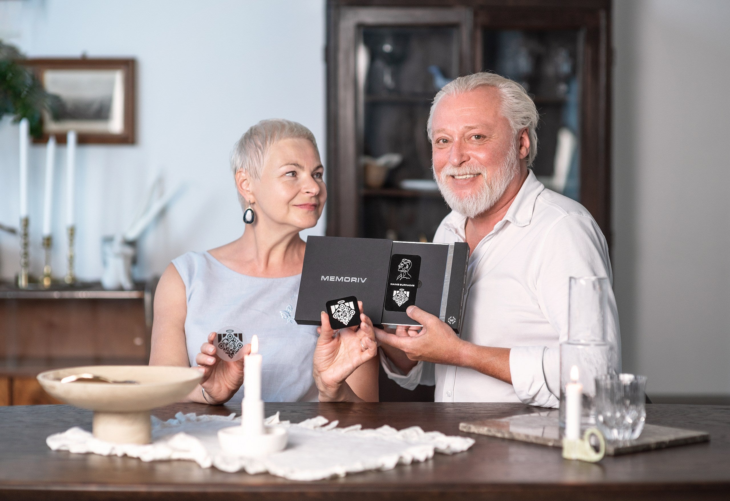 Older couple holding Memoriv medallions and presentation box